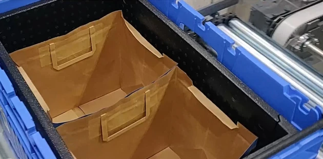 Header erecting inlays and placing paper bags